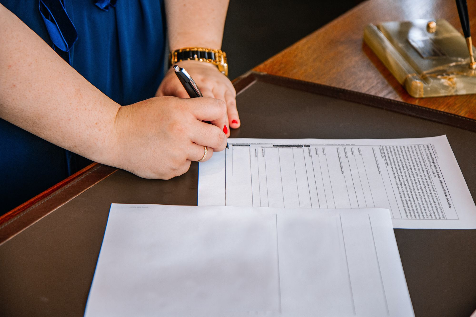 Closeup of a person's hands completing a form