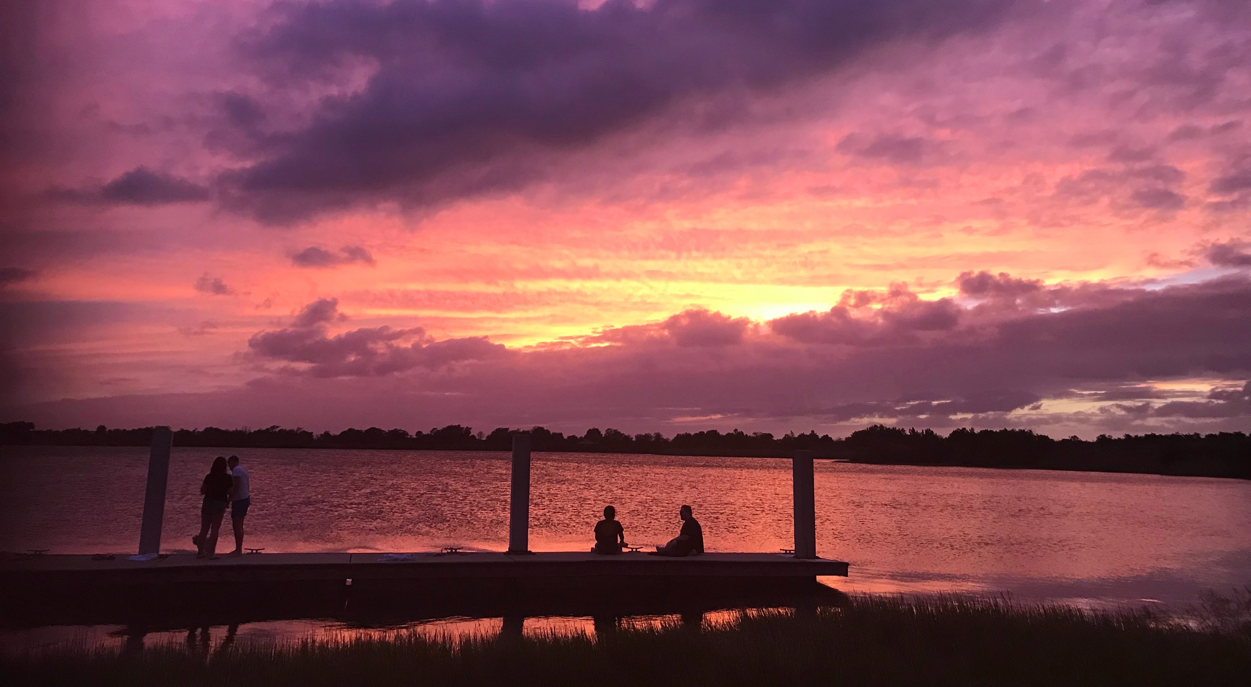 Four people against a purple sky in Sunset Cove Amphitheater, Boca Raton, Florida, USA