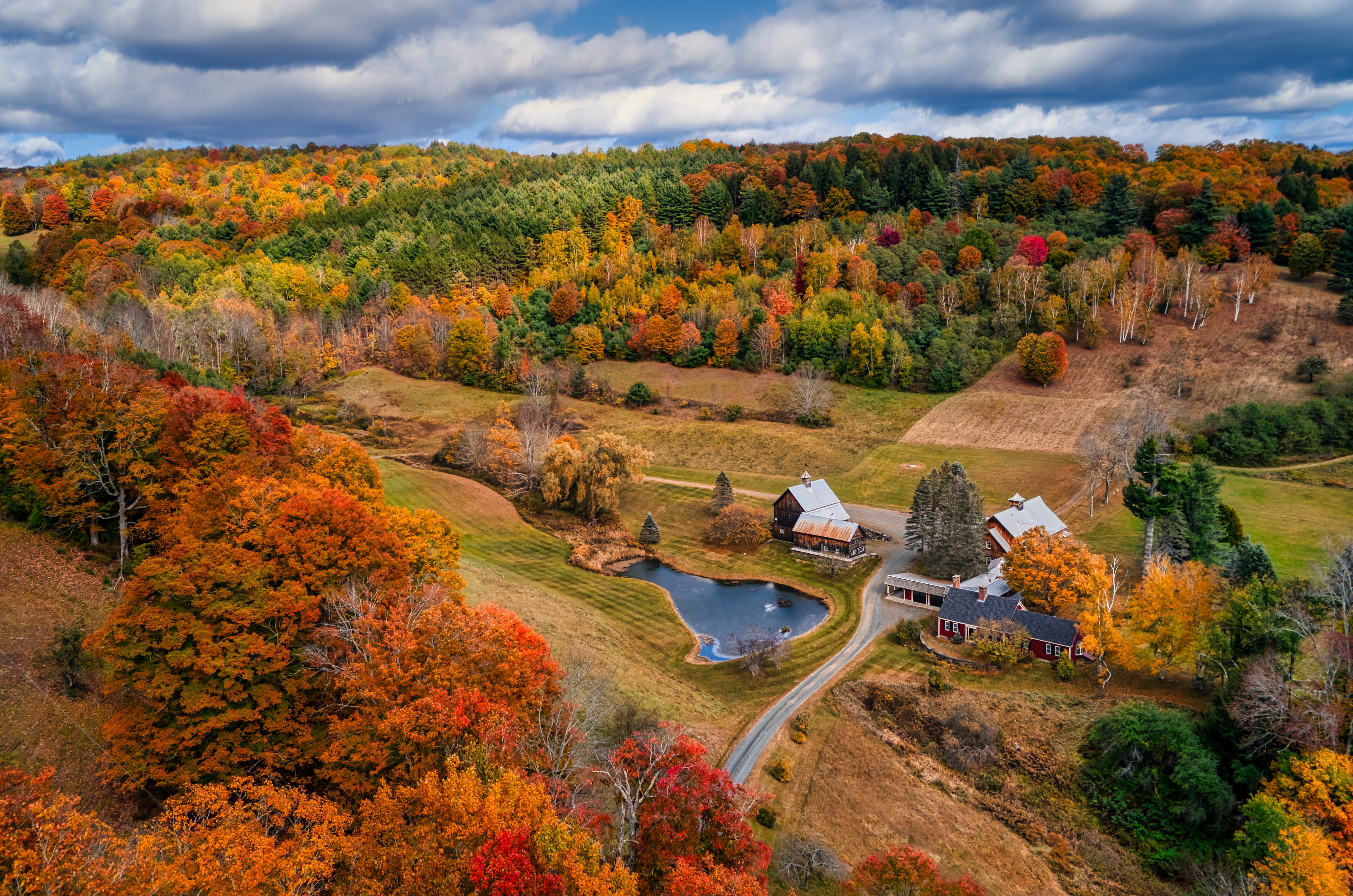 A barn nestled in a valley during fall, Vermont, USA